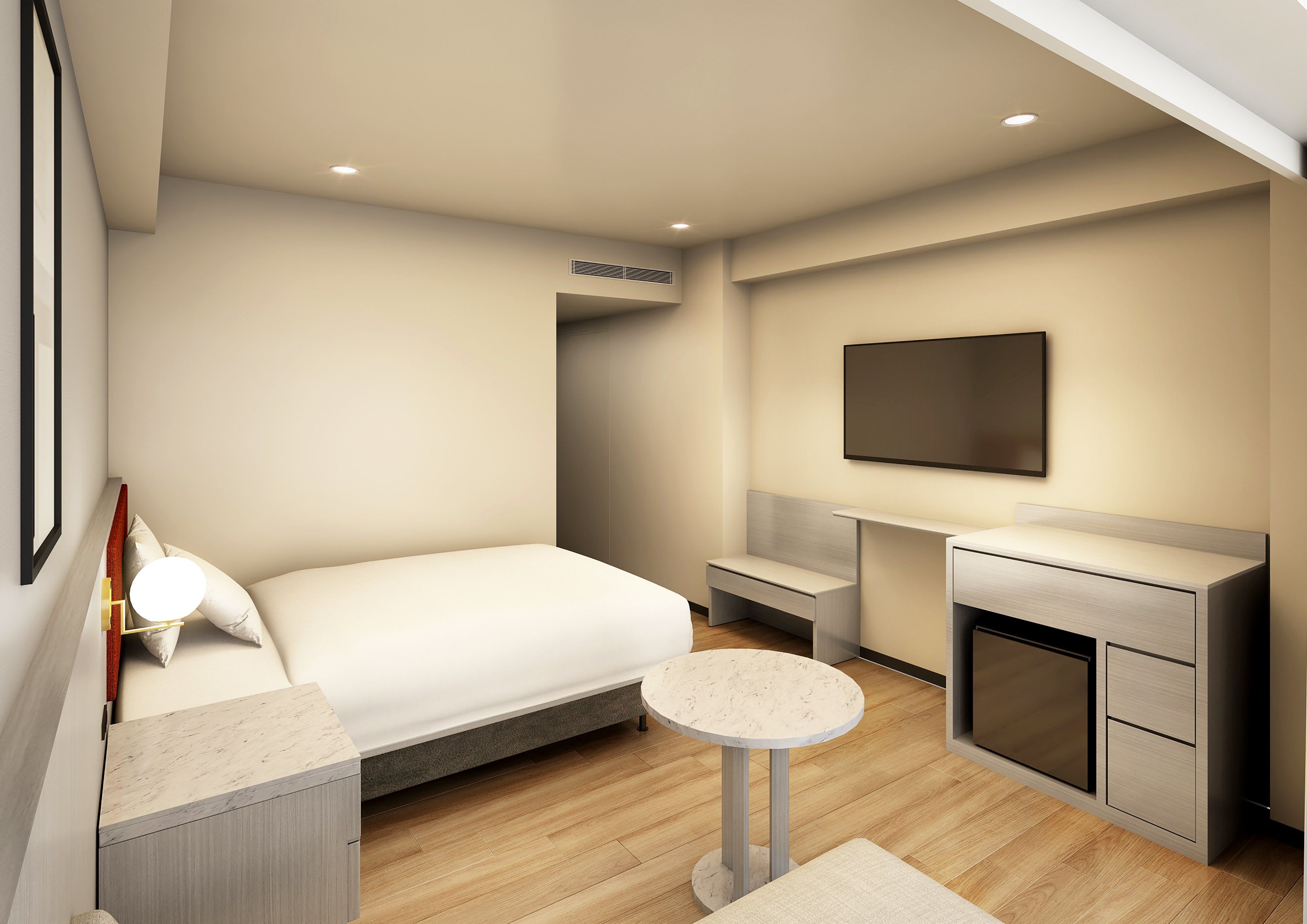 Habitación de hotel moderna con cama, mesita de noche, una pequeña mesa redonda, televisor montado en la pared y armario empotrado.