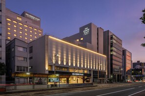 Un edificio moderno con un letrero destacado para ANA Crowne Plaza by IHG.