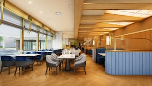 A modern restaurant interior with high ceilings, natural light, and a mix of seating arrangements. - ANA Crowne Plaza Kochi by IHG (Kochi)