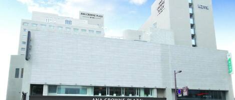 A modern building with a prominent sign for ANA Crowne Plaza.