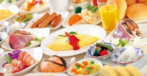 A variety of food items on plates, including salmon, eggs, and vegetables.