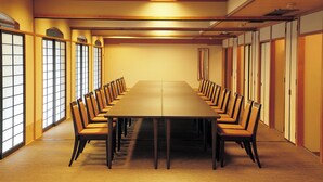 A conference room with a long table and chairs, wooden paneling, and large windows. - ANA Crowne Plaza Kochi by IHG (Kochi)