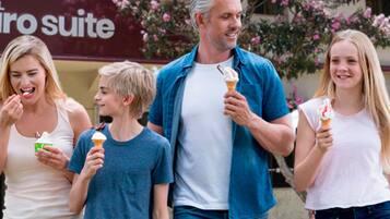 A family walking outside a hotel with a sign reading "HOTEL euro suite".