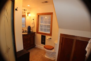 A bathroom with a toilet, vanity, and a window with blinds. - Millsap-baker Estate (Damascus)