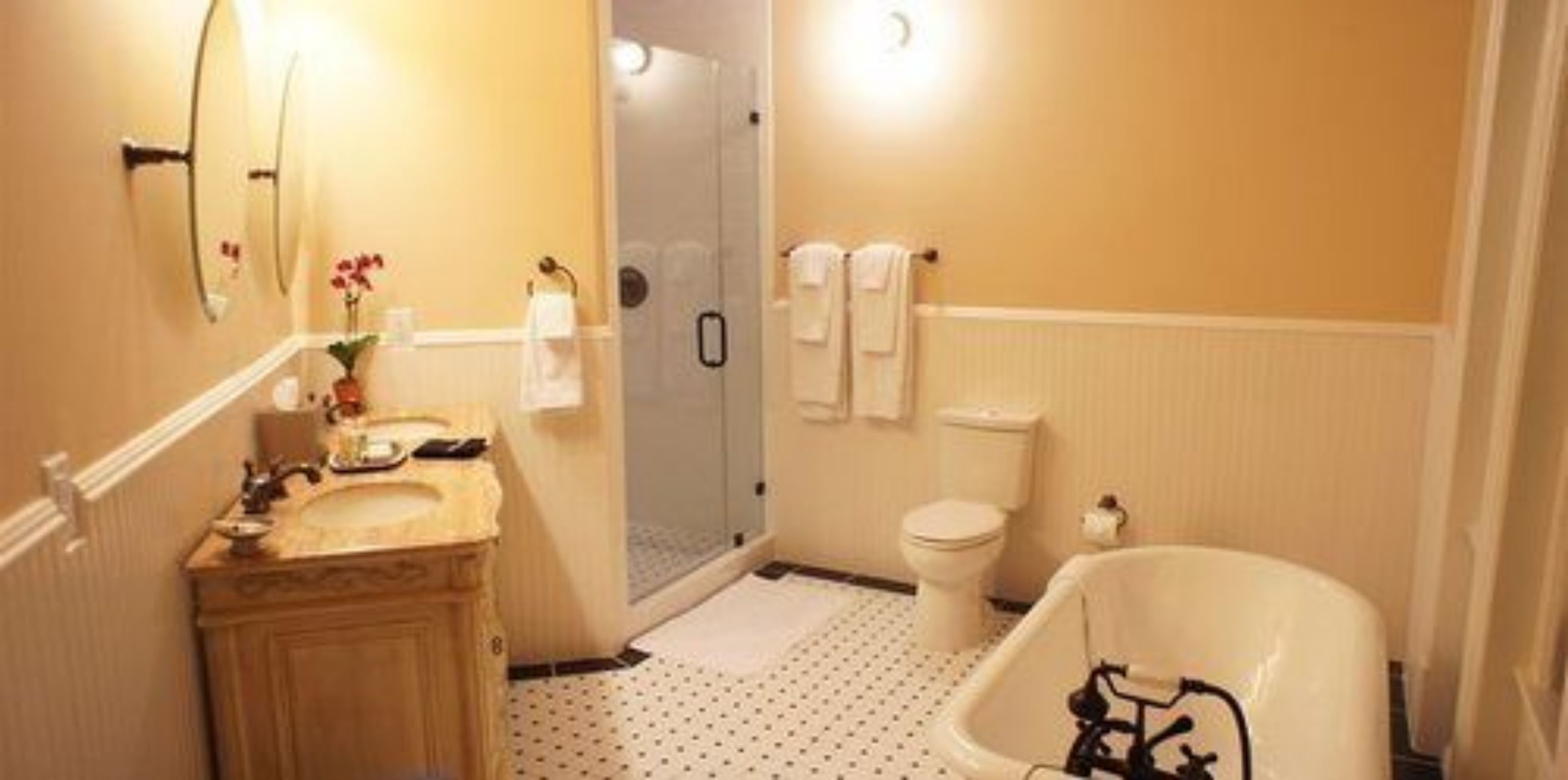 A bathroom with a sink, toilet, shower, and bathtub.
