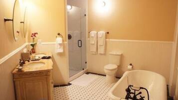 A bathroom with a sink, toilet, shower, and bathtub.