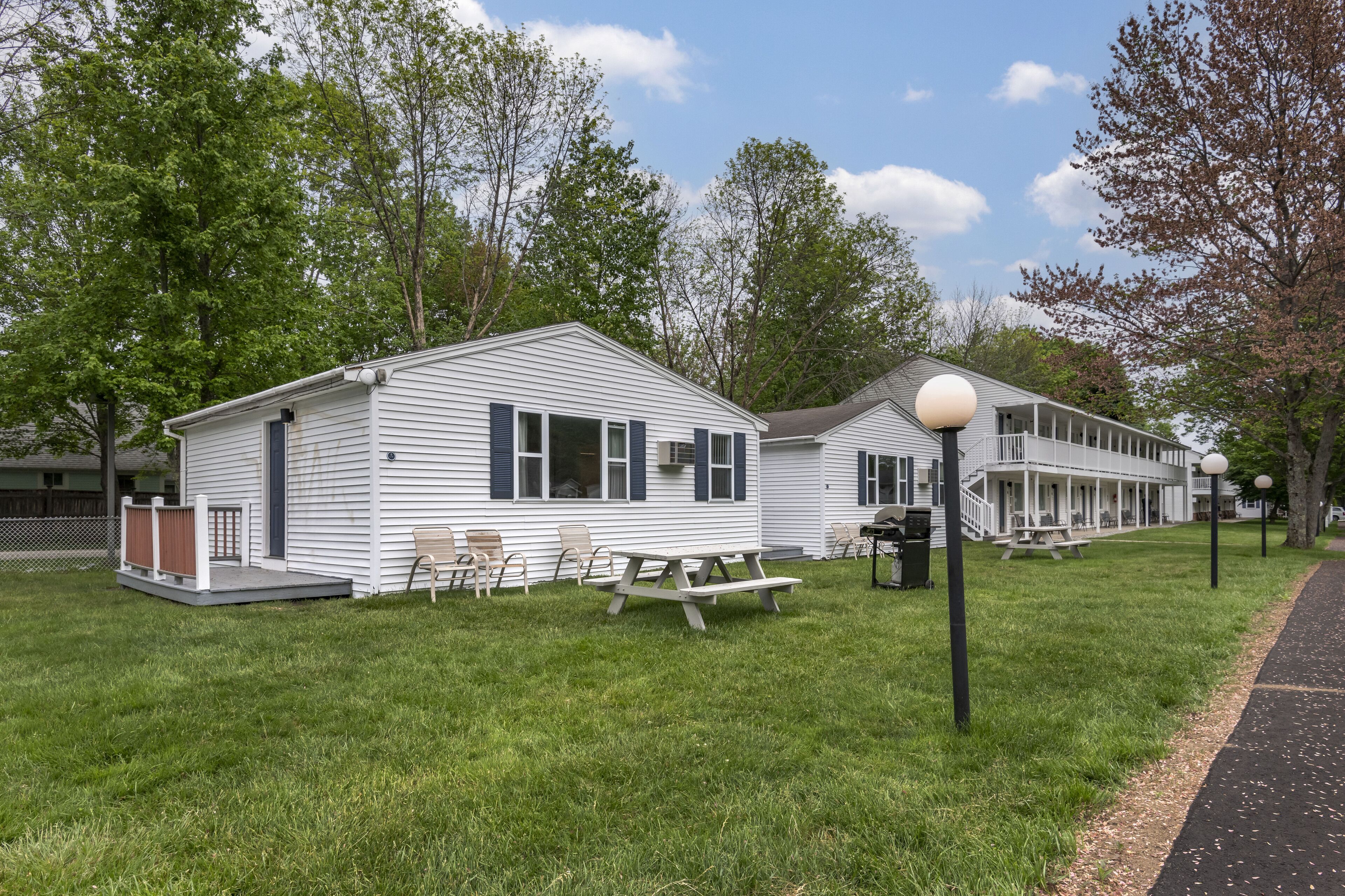 A row of mobile homes with picnic tables and outdoor seating.