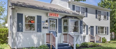 A two-story building with a 'OFFICE' sign above the entrance.