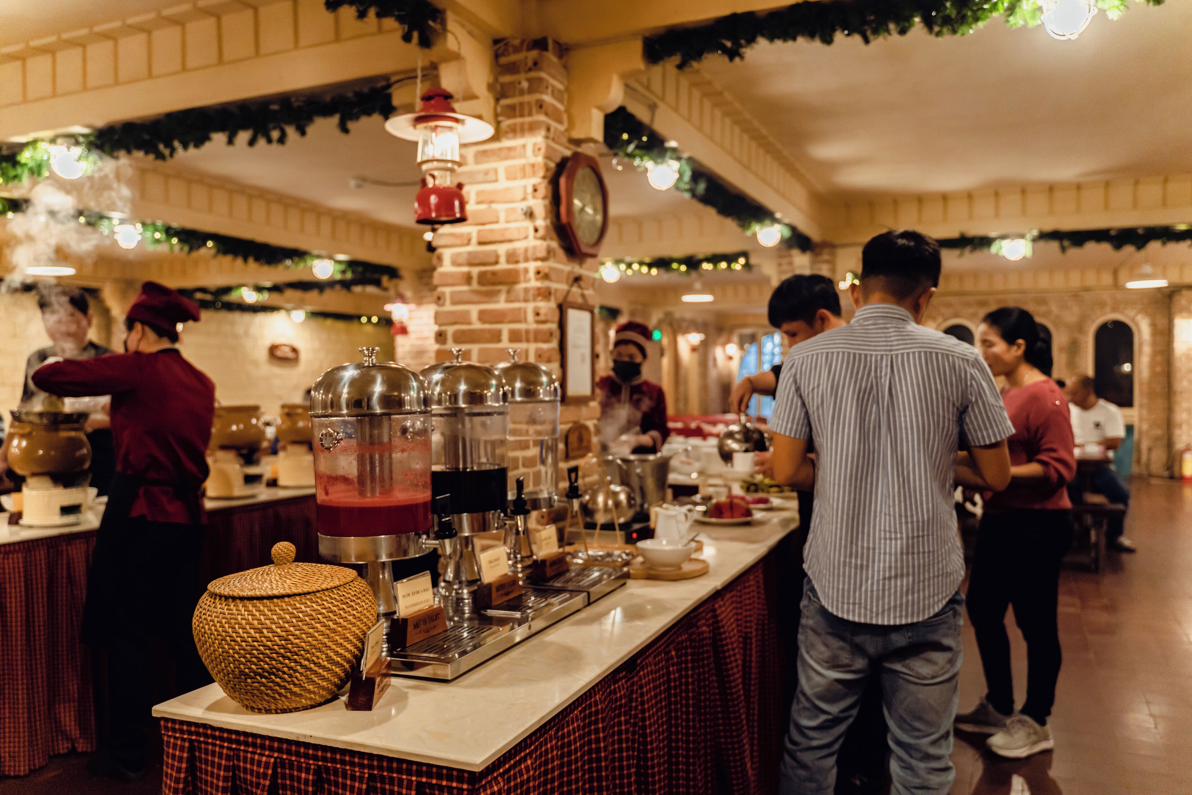 A bar area with a coffee machine, a basket, and a brick wall.