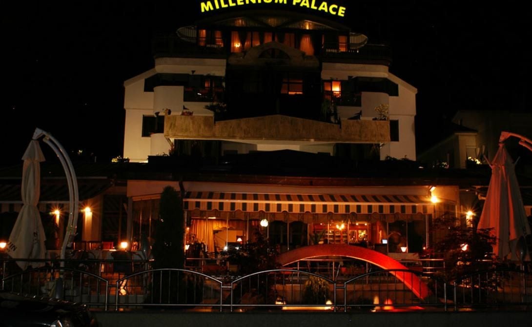 A multi-story hotel with a prominent sign reading 'Millennium Palace.'