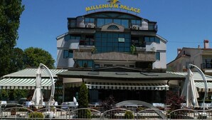 A multi-story building with a sign reading "Millennium Palace".