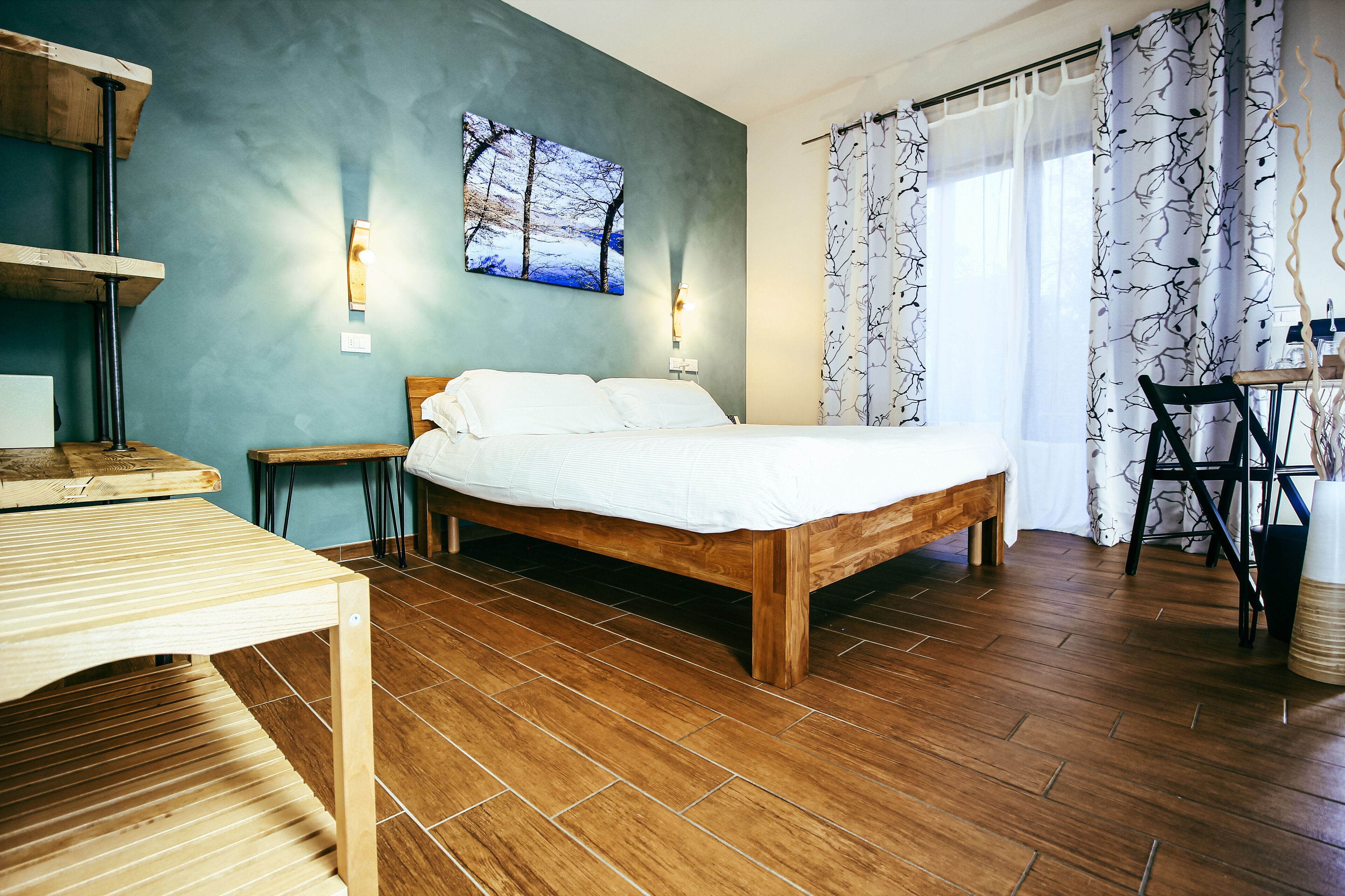 A bedroom with a wooden bed, a desk, and a chair.