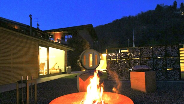A fire pit with logs in the center, surrounded by a gravel area. - Agriturismo Il Cucchiaio di Legno (Orta San Giulio)