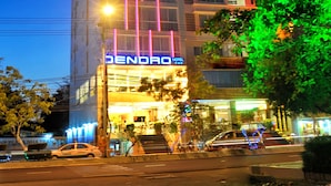 A multi-story hotel with a prominent 'DENDRO' sign, featuring a modern design with illuminated vertical lines and a flat roof. - Dendro Hotel (Nha Trang)