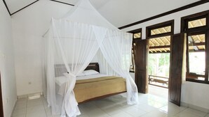 A room with a bed under a white canopy, wooden door frames, and a tiled floor. - Kangkung Cottages (Karangasem)