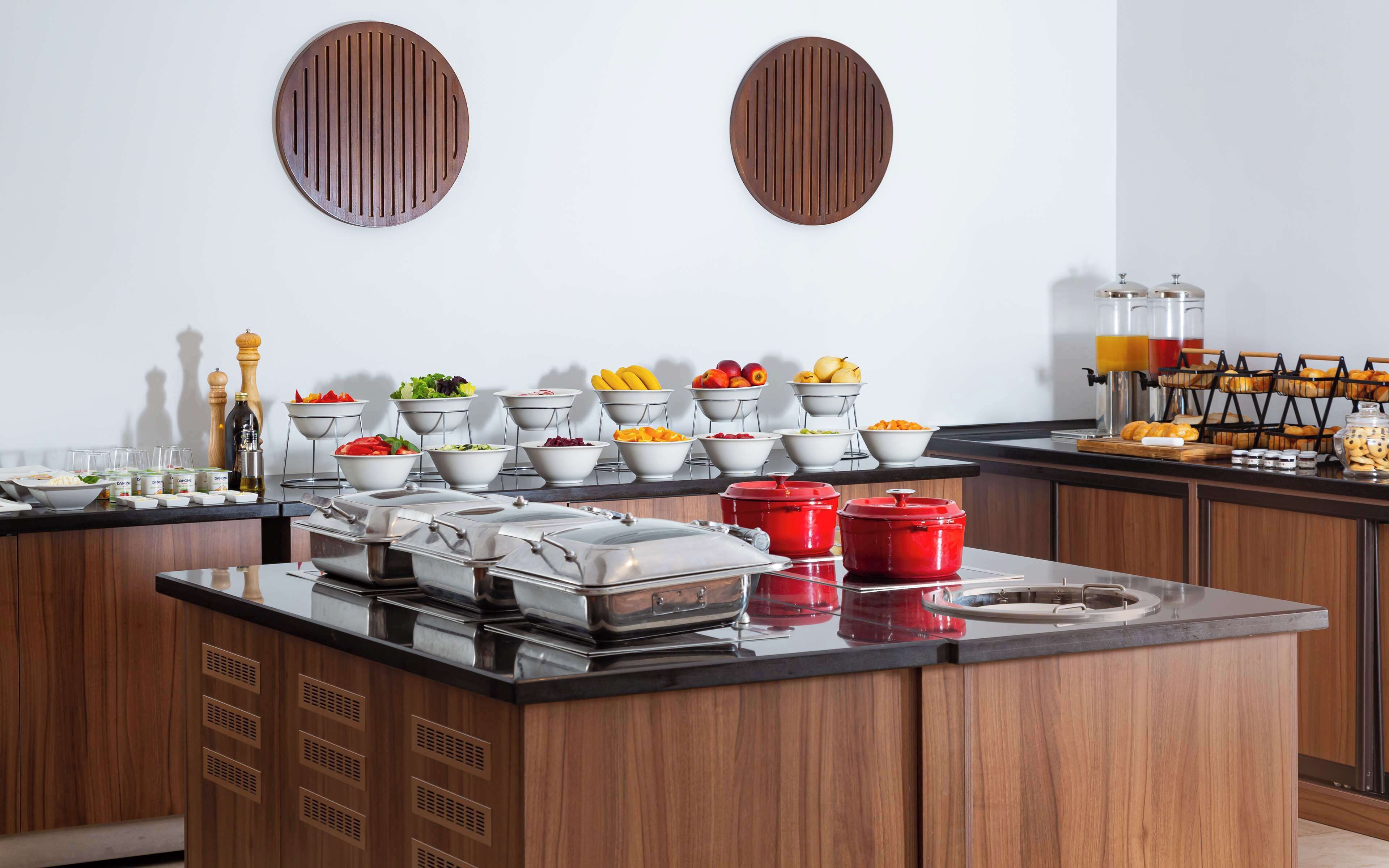 A buffet setup with various food items and beverages.