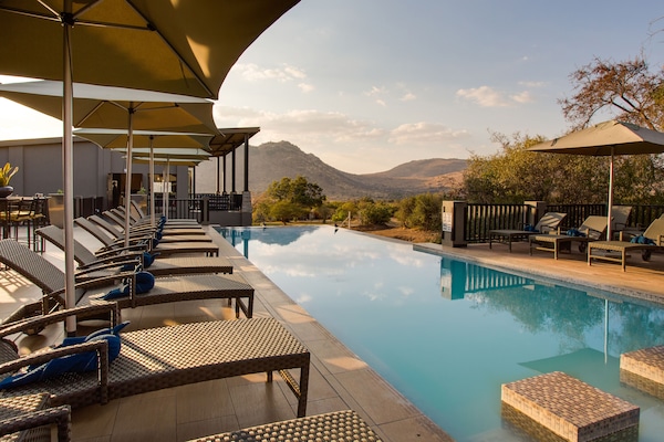 Outdoor pool, open 6:00 AM to 6:00 PM, pool umbrellas, sun loungers
