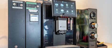 A coffee machine with a Starbucks logo, a menu board, and a digital display.