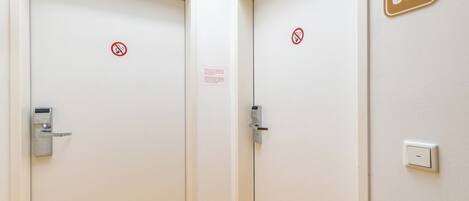 A corridor with two doors, one marked with a '602' sign, and a yellow floor.