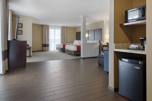 A hotel room with a bed, a desk, a microwave, and a refrigerator. - Comfort Suites and Conference Center (Worthington)