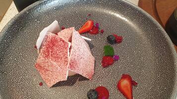 A dessert plate with various fruits and a textured bowl.