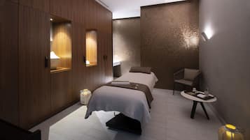 A modern hotel room with a large bed, a small table, a chair, and a decorative floor lamp.