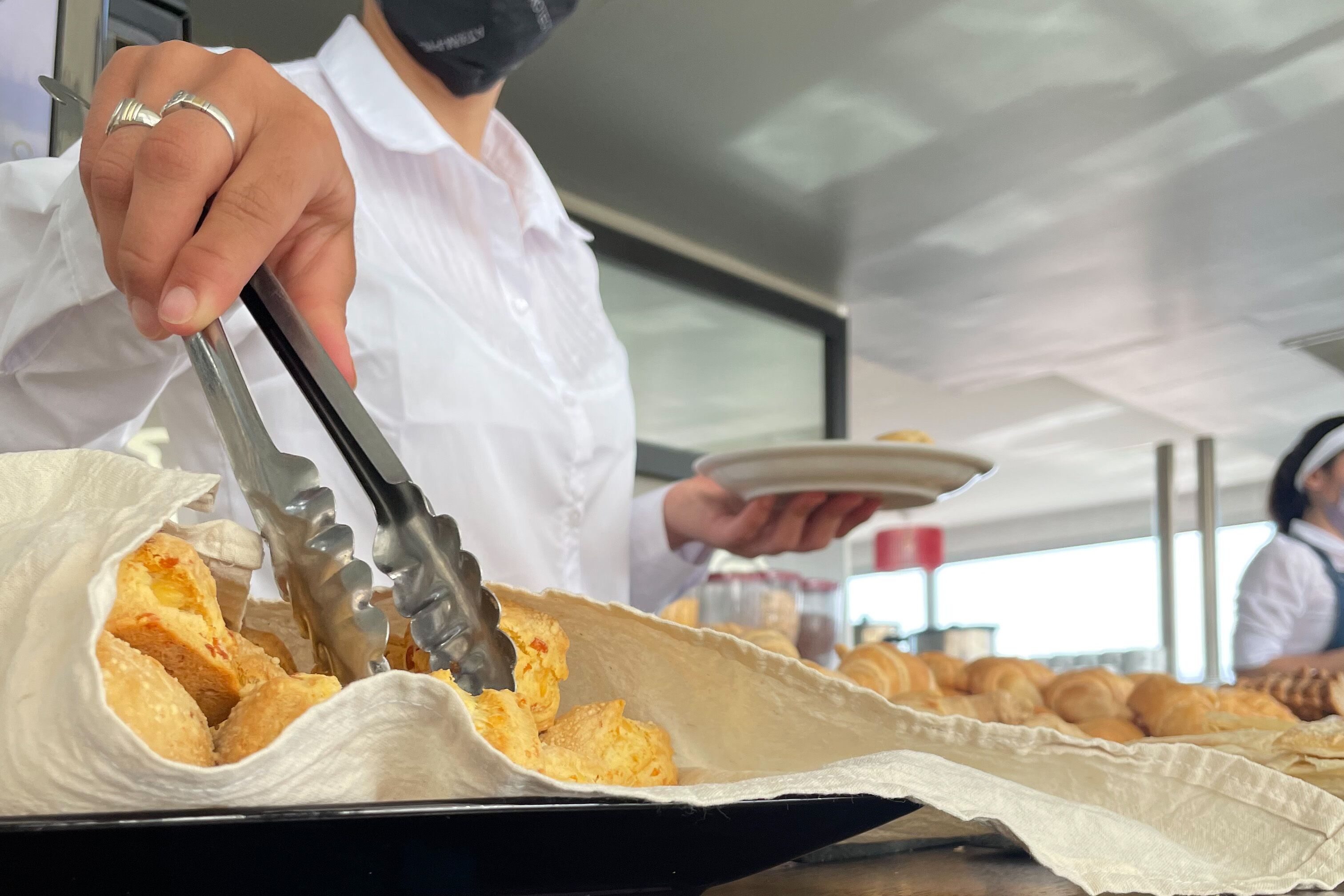A person serving food from a tray.