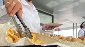 A person serving food from a tray.