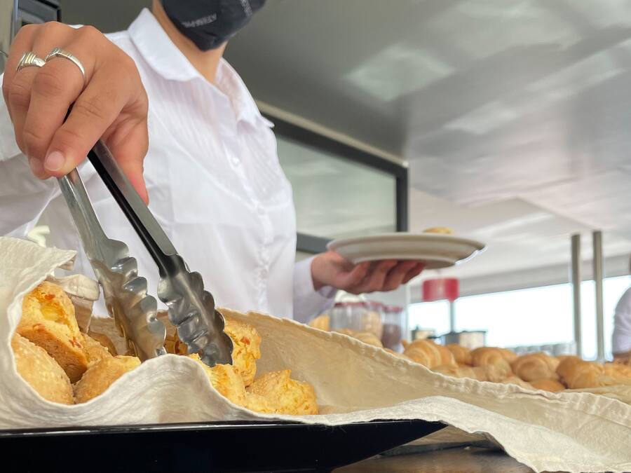 A person serving food from a tray.