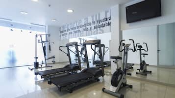 A gym with treadmills, elliptical machines, and weight equipment.