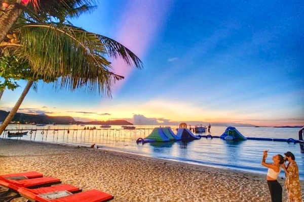 On the beach, white sand, sun loungers, beach umbrellas