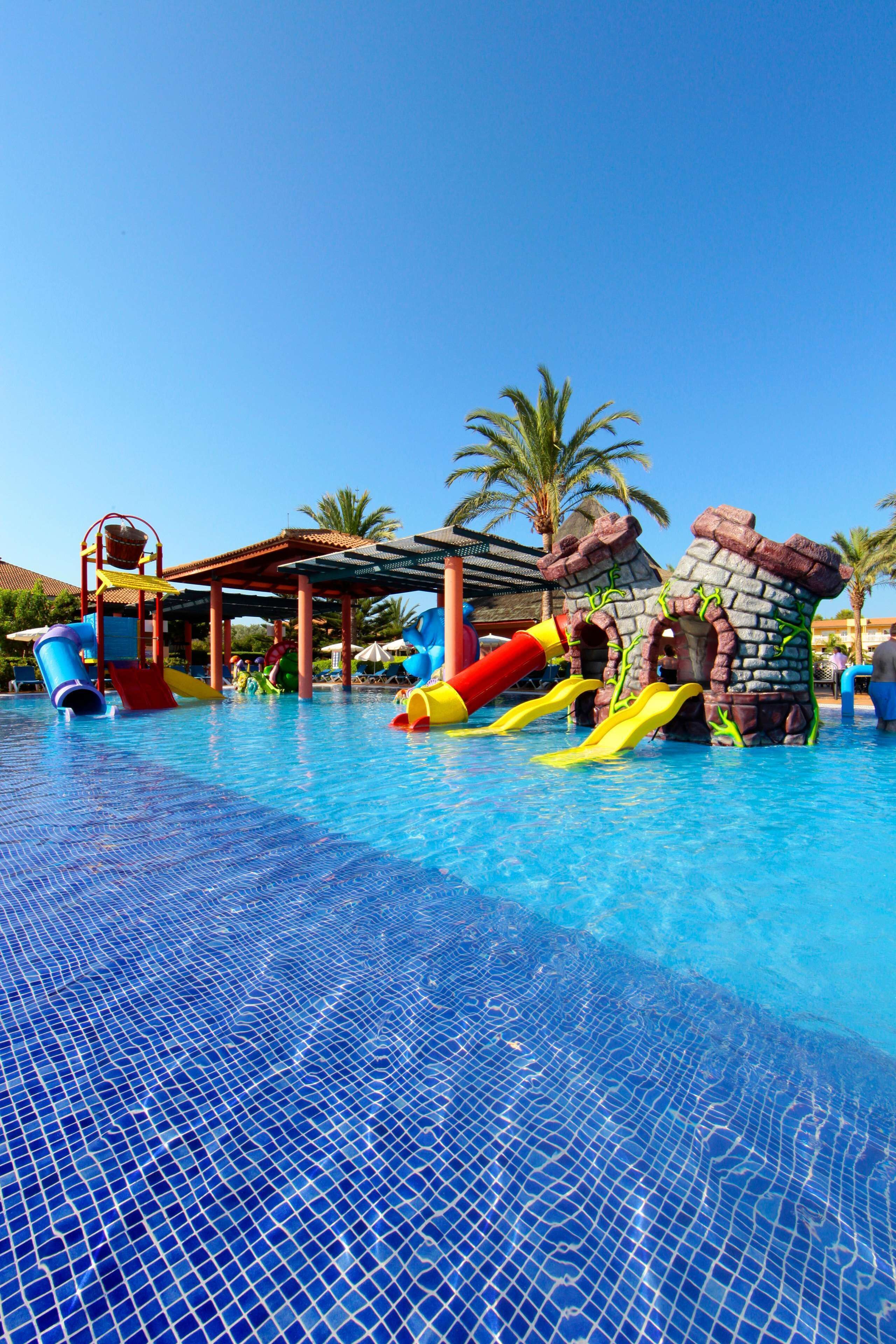 A swimming pool with slides and water features.