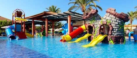 A swimming pool with slides and water features.