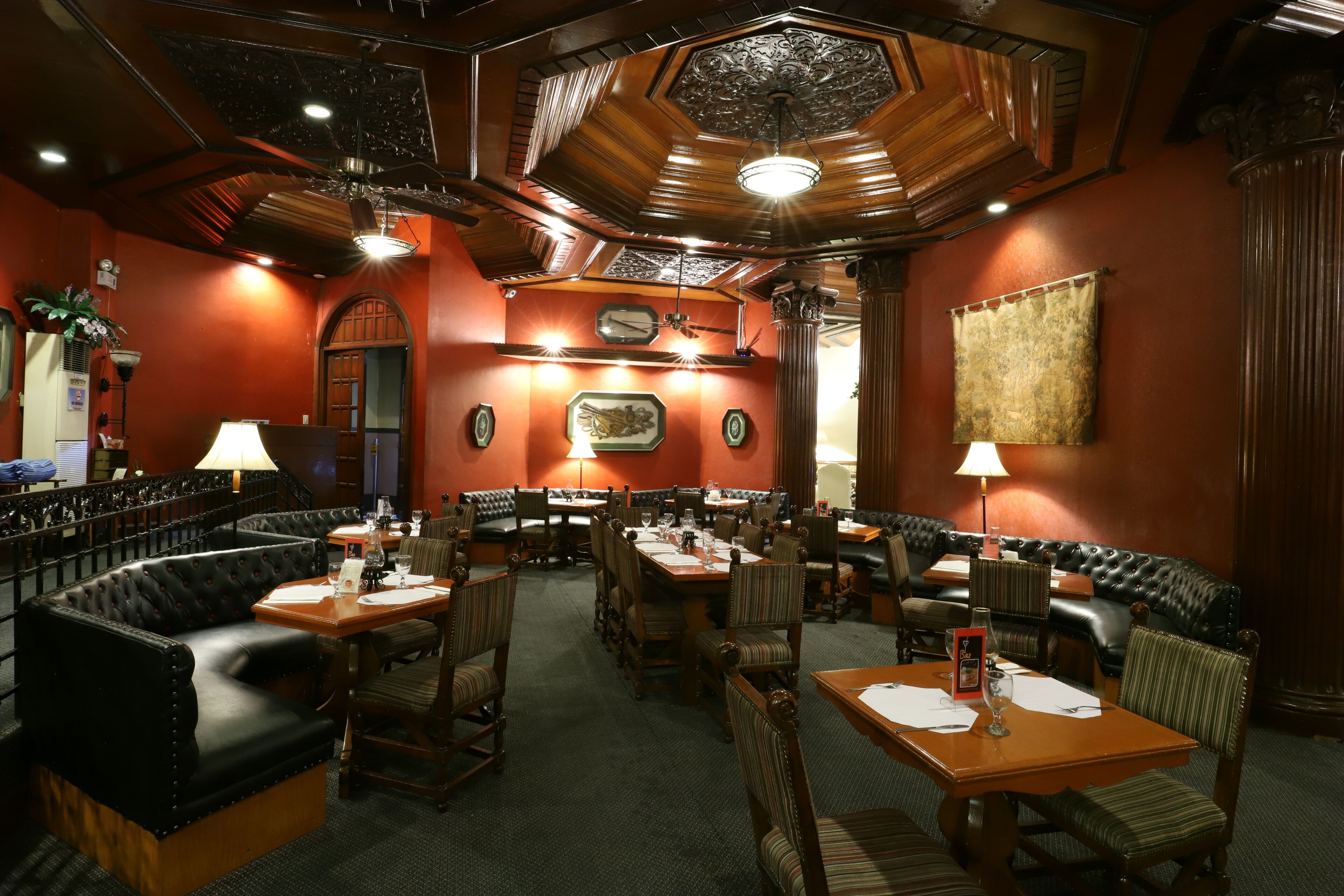 A restaurant with booths, tables, and a bar area.