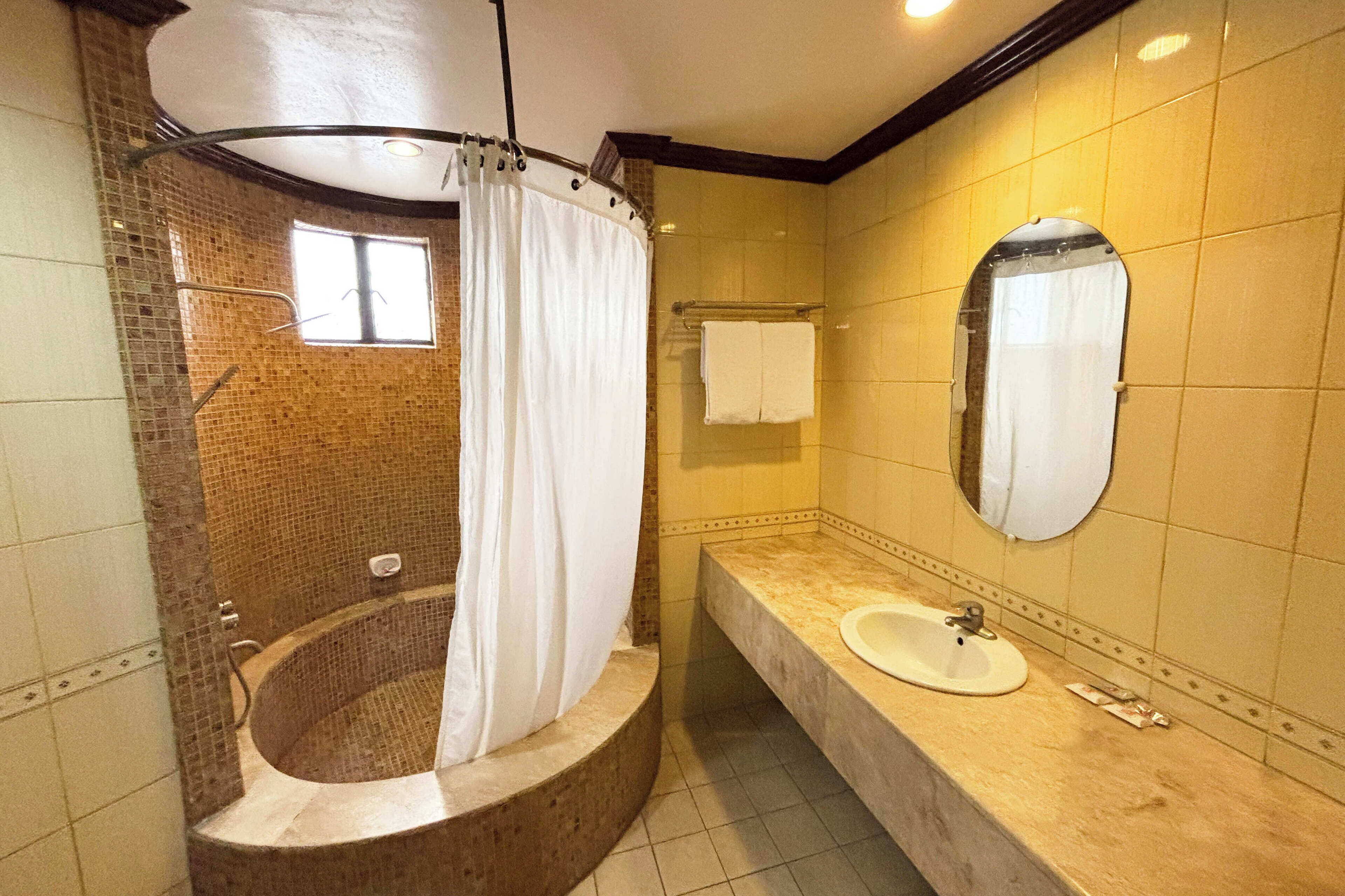 Deluxe Queen | Bathroom | Combined shower/tub, rainfall showerhead, free toiletries, hair dryer
