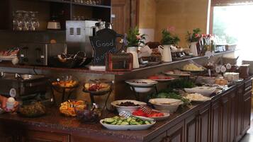 A buffet with various food items and a sign that reads "Good Morning".