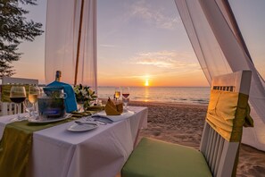 On the beach, white sand, beach umbrellas, beach towels