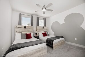 A bedroom with two beds, a ceiling fan, and a large window with curtains. - Clean, Cozy & Chic Apartment. CDC Cleaning Standards! Just 3 Miles From Disney (Kissimmee)