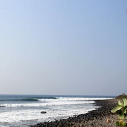 On the beach, black sand