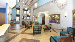 A spacious lobby with a high ceiling, multiple seating areas, and a bar. - Must SEE Championsgt 9bed w/ Pool/spa/gmrm-1300 (Davenport)