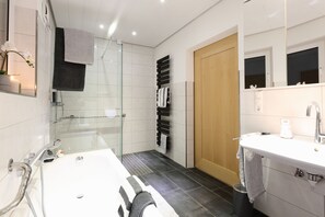 Bathtub, hair dryer, towels, soap