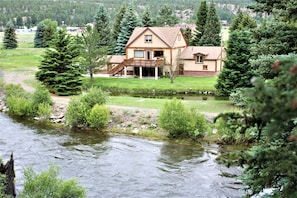Stroll up to this charming home, surrounded by lush gardens and a serene water feature.
