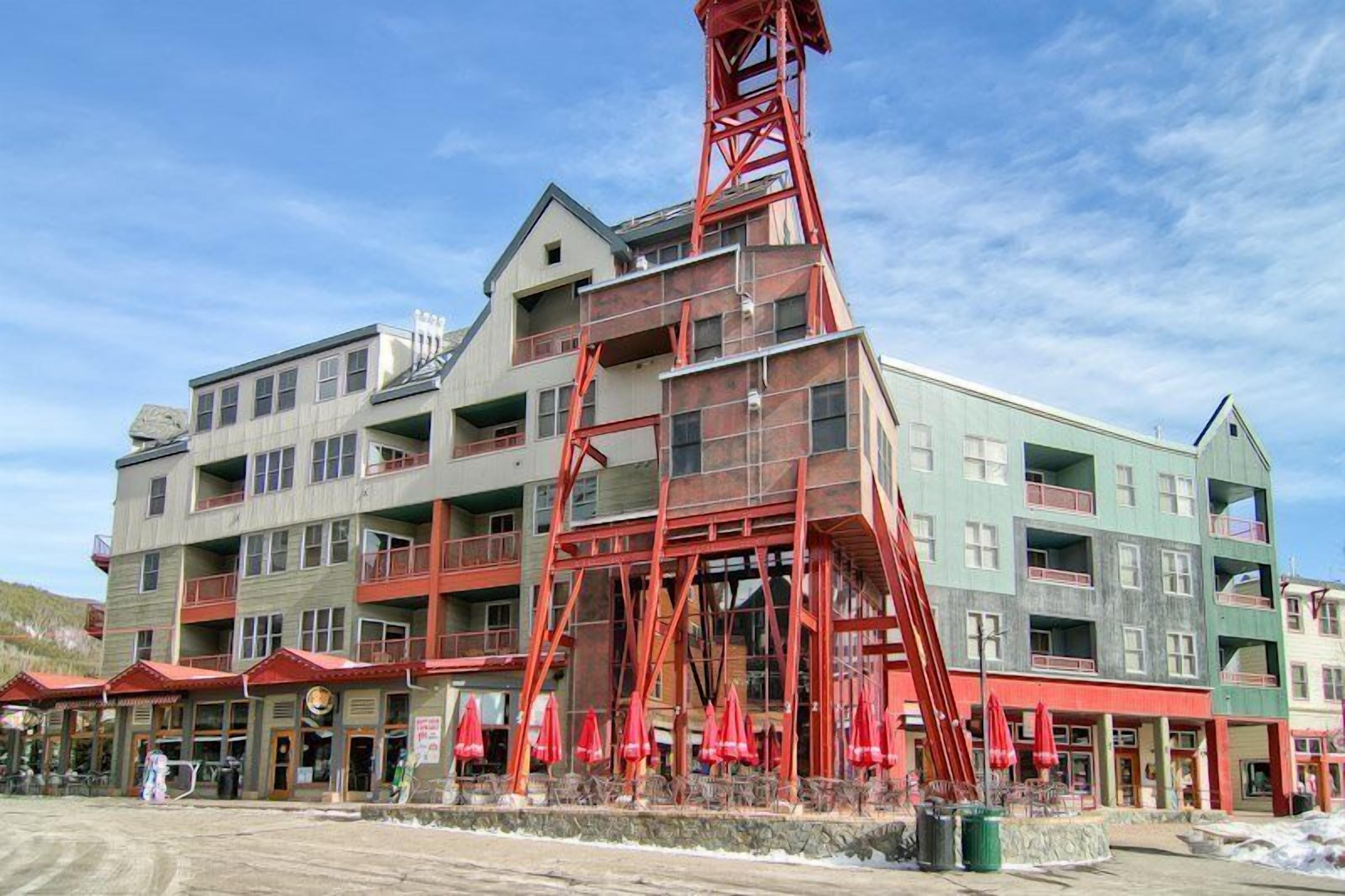 A multi-story hotel with a prominent red tower structure.