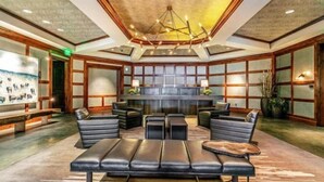 A lobby with a reception desk, seating area, and a large artwork on the wall. - Vail Ritz-carlton 3 Bedroom Residence in Lionshead Village (Vail)