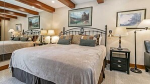 A bedroom with a large bed, two bedside tables with lamps, and framed artwork on the walls. - 2 Bedroom Antlers Vacation Rental With Incredible Slopeside Views and Just a Short Walk to Gondola and Lionshead Village (Vail)