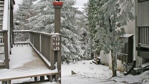 A wooden bridge with directional signs pointing to numbers 13, 14, and 15. - Whistlepunk 13 Spacious 4 Br Condo Slope Side (Snowshoe)