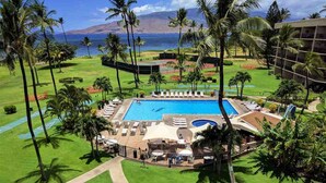 A resort with a central swimming pool, lounge areas, and a view of the ocean. -  OCEAN FRONT: spacious, remodeled 4th floor condo (Kihei)