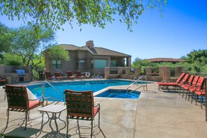 A swimming pool with lounge chairs and a patio area. - Luxury Ventana Canyon Condo + Pools + Spas + Hiking + Golf + Sabino Canyon! (Tucson)