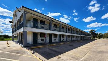 A two-story motel with a central corridor and individual rooms on either side.