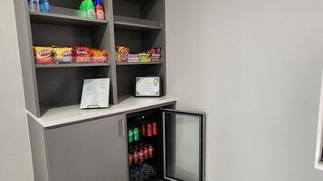 A snack and drink vending area with various snacks and beverages.